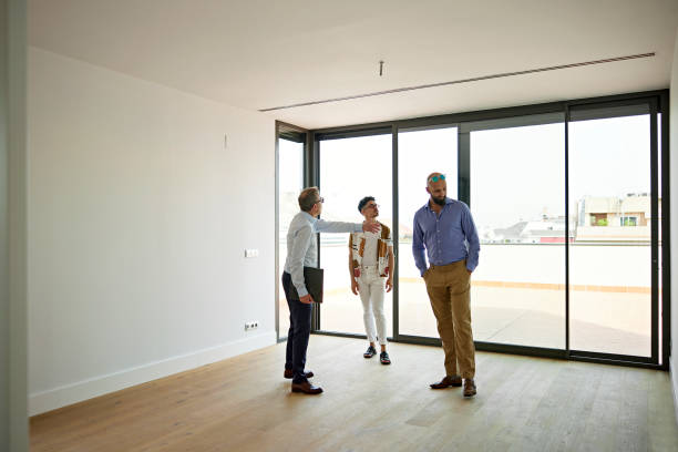 istock Prospective Buyers Looking at Unfurnished Apartment Interior 1344886181
