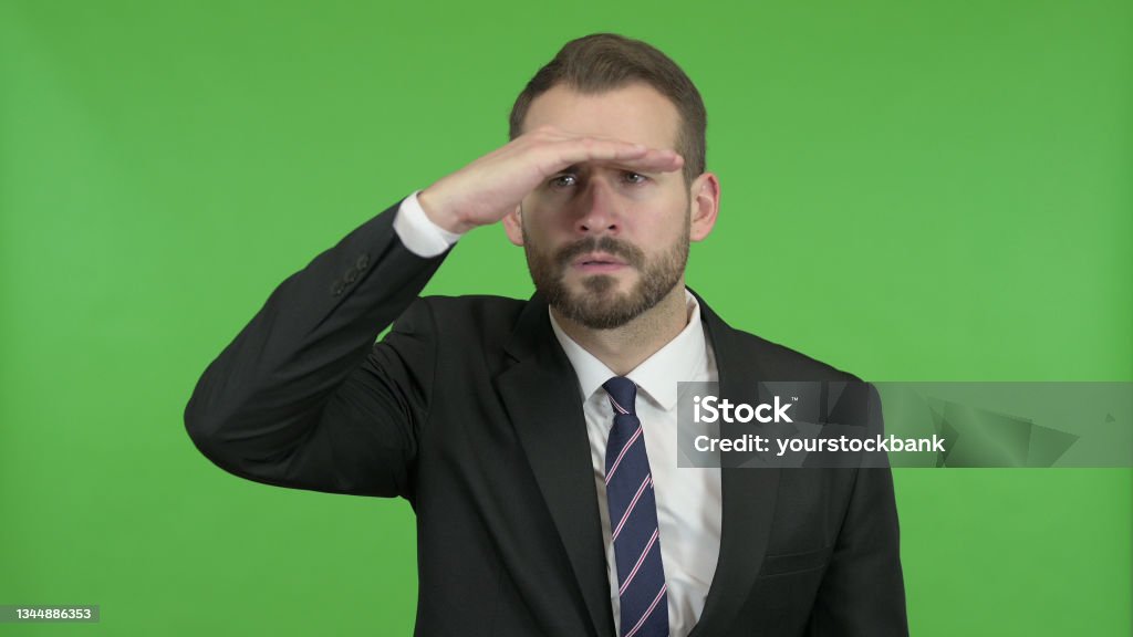 Ambitious Businessman trying to Look far off against Chroma Key 20-29 Years Stock Photo