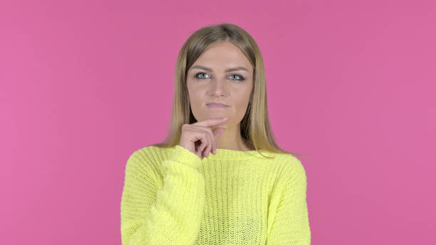 istock Thinking Young Girl Brainstorming, Pink Background 1344887917