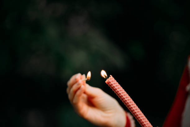 istock burning candle in the hand 1344888485