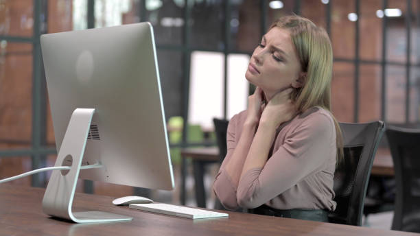 istock Tired Woman having Neck Pain while Working on Computer 1344888728