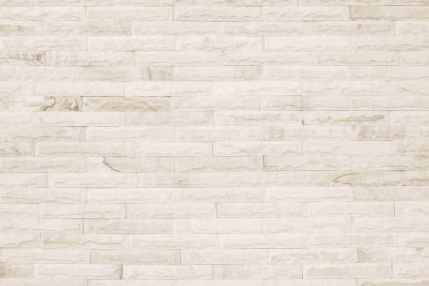 istock Empty background of wide cream brick wall texture. Beige old brown brick wall concrete or stone textured, wallpaper limestone abstract flooring/Grid uneven interior rock. Home decor design backdrop. 1344888940