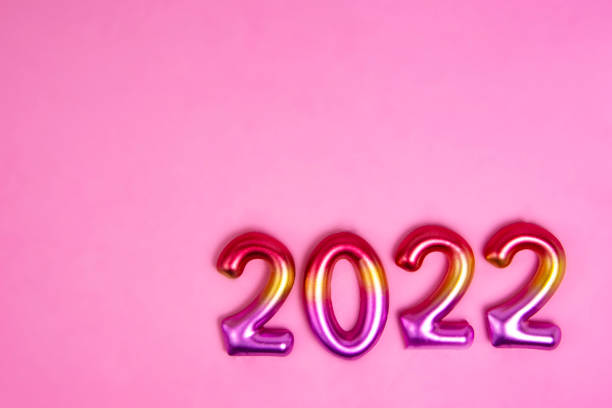 istock Multicolor creative 2022 numbers on decorative pink background with copy space 1344891378