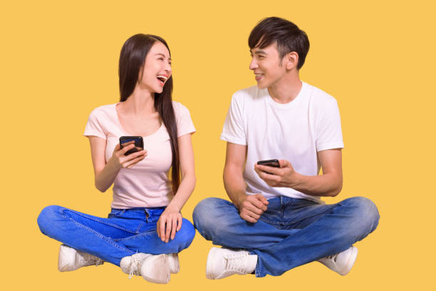 istock Cheerful young asian couple sitting on floor 1344891398