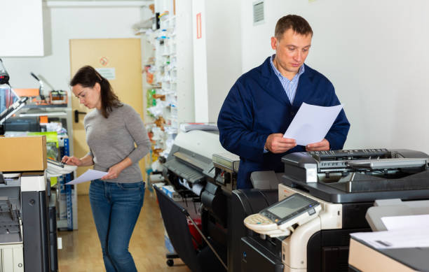 istock Printing company employees work on various printing machines 1344892584