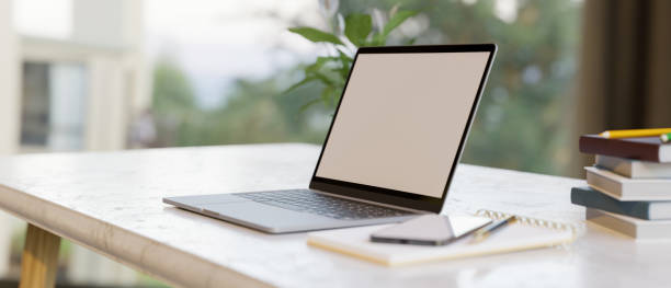 istock Simple home workspace with laptop computer blank screen mockup with supplies 1344894093