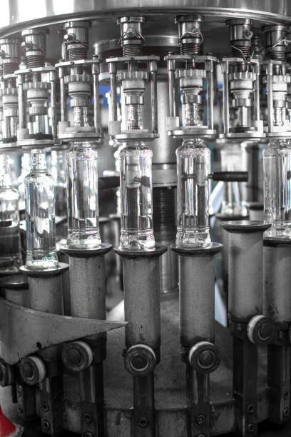 istock Full bottles on conveyor preparing for sale 1344897282