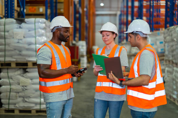 istock A small group of warehouse workers has a meeting in a large distribution center 1344897654