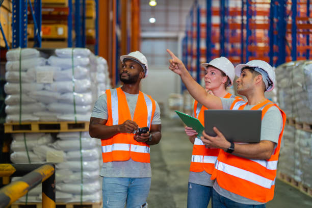 istock A small group of warehouse workers has a meeting in a large distribution center 1344897669