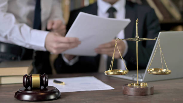 istock Close up Shoot of Advocate Discussing Documents with Assistant 1344899993