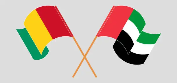 Vector illustration of Crossed and waving flags of Guinea and the United Arab Emirates