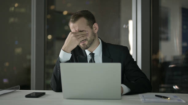 istock Sleepy Businessman keep working on Laptop at Night 1344902496
