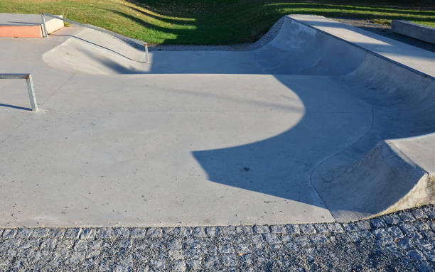 istock Skateboard park with concrete cement surface with concrete skateboard obstacles is designed for roller sports. Cycling is not allowed except for freestyle bikes. Protective clothing, head, elbow knee 1344902499