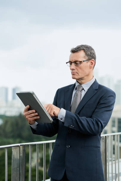 istock Mature Businessman With Tablet 1344902534