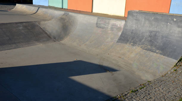 istock Skateboard park with concrete cement surface with concrete skateboard obstacles is designed for roller sports. Cycling is not allowed except for freestyle bikes. Protective clothing, head, elbow knee 1344902768