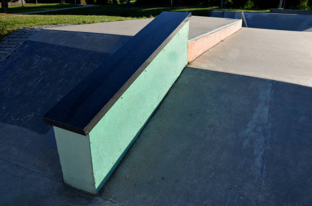 istock Skateboard park with concrete cement surface with concrete skateboard obstacles is designed for roller sports. Cycling is not allowed except for freestyle bikes. Protective clothing, head, elbow knee 1344902805