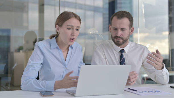 istock Business people Shocked while Working on Laptop 1344903840