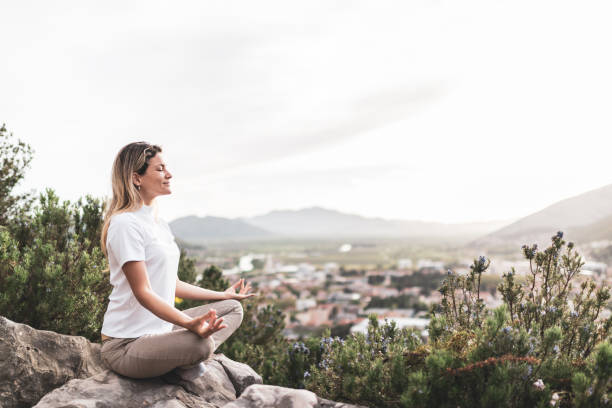 istock Young woman preforms yoga in mountains at sunset 1344906868