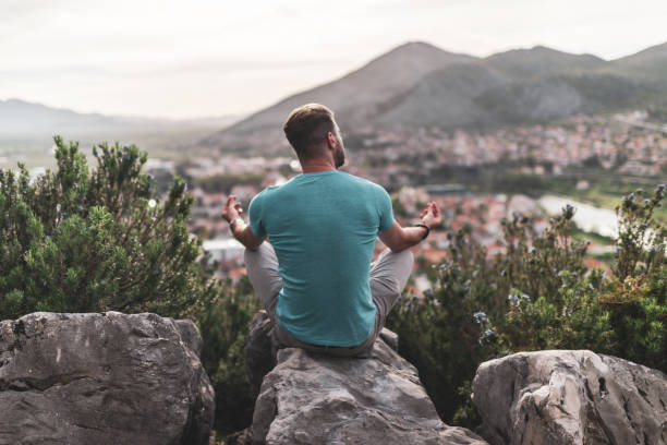 istock Young man preforms yoga in mountains at sunset 1344906882