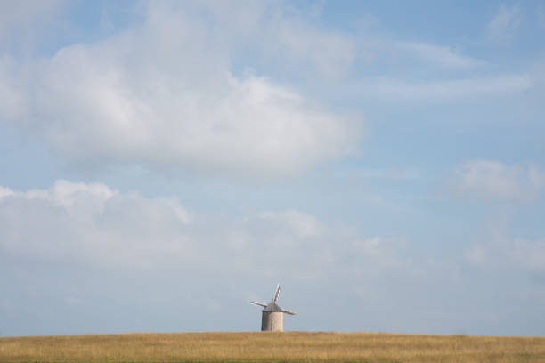 istock Windmill in nature in front of a blue sky 1344908094