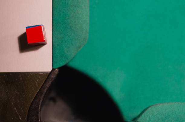 Green pool table with a blue chalk. Viewed from above.