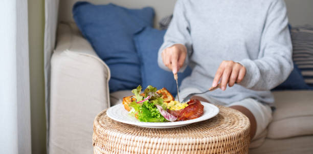 istock A woman eating American breakfast at home 1344909429