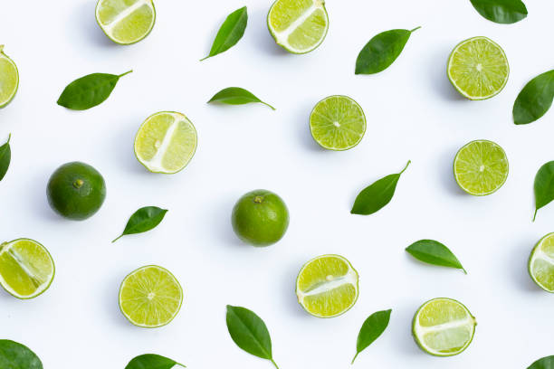 istock Fresh limes with green leaves on white background. 1344910494