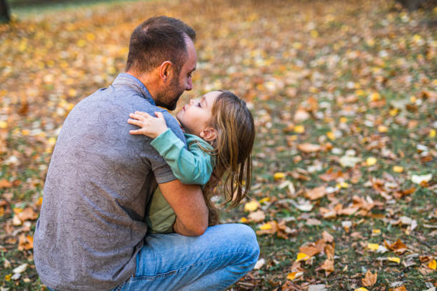 istock Little girl embracing father 1344911701