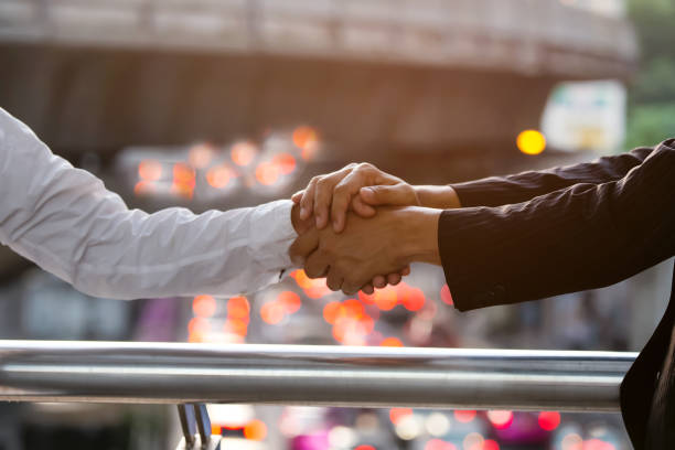 business trust commitment which business partners holding hands,help, trust ,support ,empathy and factors relationship marketing for reach successful achievement,trust and commit concept. - trust imagens e fotografias de stock