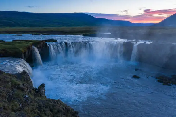 The aerial view of the beautiful waterfall of Godafoss at link sunset, Iceland in the summer season.