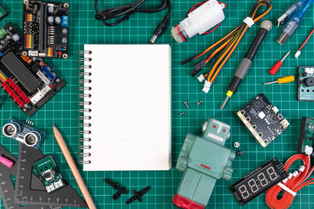 istock Top view of robot microcontrollers board and sensors object equipment in robotics laboratory school. 1344913656