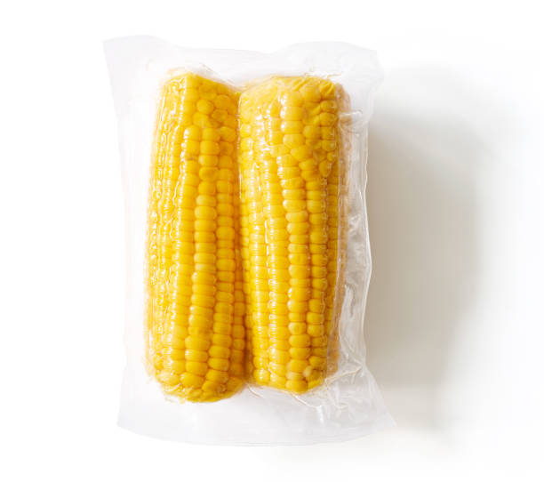 yellow corn ears packaged and sealed; isolated on white, from above - packaged food imagens e fotografias de stock