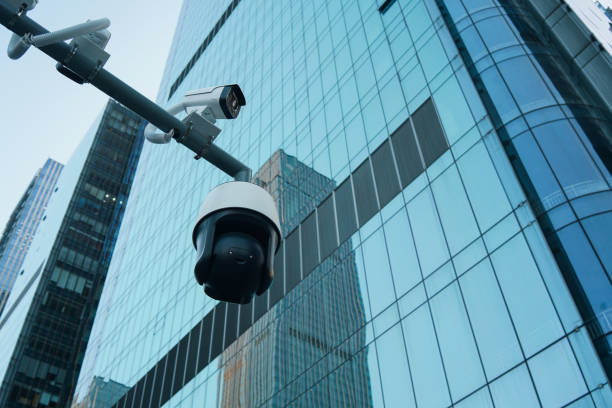 CCTV camera with modern financial buildings in downtown, property and financial security concept. stock photo