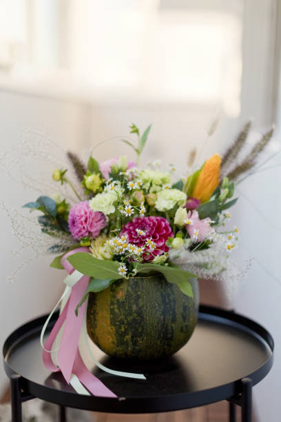 istock Bright fall autumn bouquet in pumpkin 1344915139