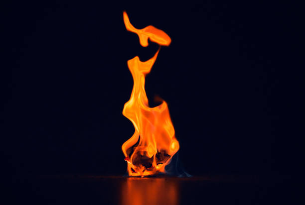 istock Studio shot of a small flame burning against a black background 1344916976