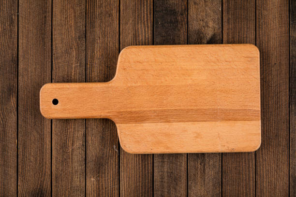 istock Light brown wooden cutting board 1344917489