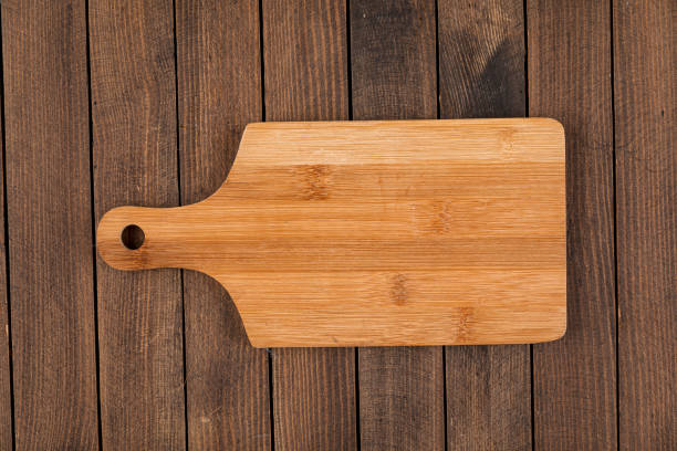 istock Light brown wooden cutting board 1344917513