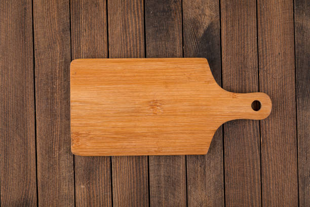 istock Light brown wooden cutting board 1344917515