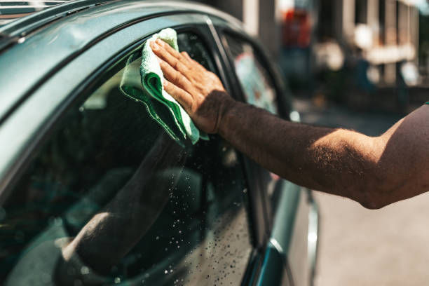 istock Mature man polishing his car with microfiber cloth. 1344918333