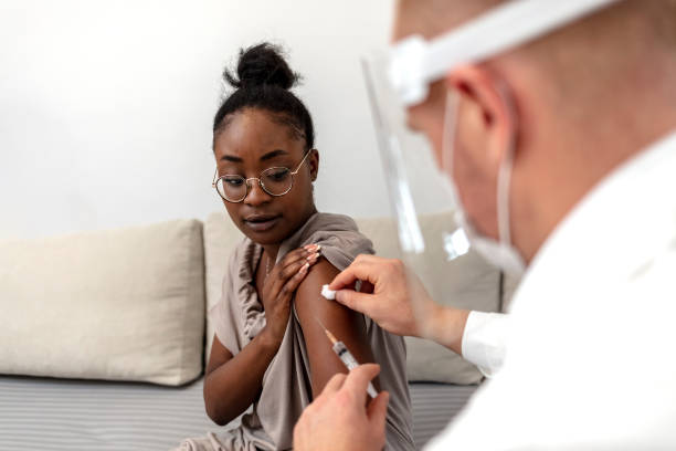 istock African-American woman taking a vaccine. 1344918514