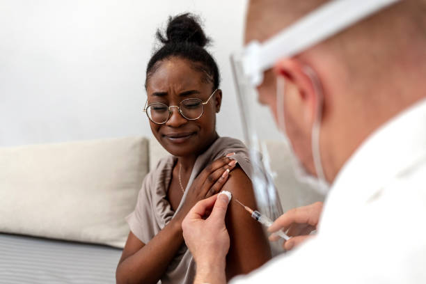 istock African-American woman taking a vaccine. 1344918702