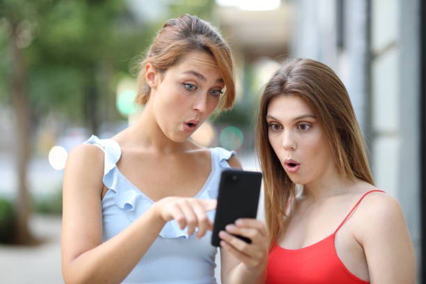 istock Two surprised women checking news on smartphone 1344922026