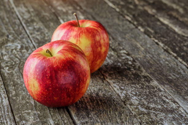 istock Green and red apples on blackboard or chalkboard background. Bright fruit composition.Red and green apple on old wooden table. Top view with space for your text 1344926247