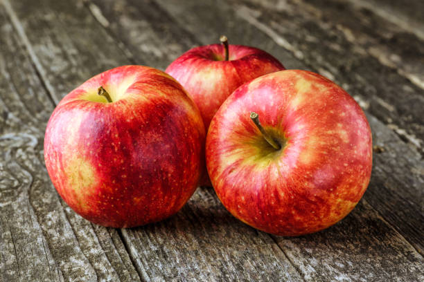 istock Green and red apples on blackboard or chalkboard background. Bright fruit composition.Red and green apple on old wooden table. Top view with space for your text 1344926262