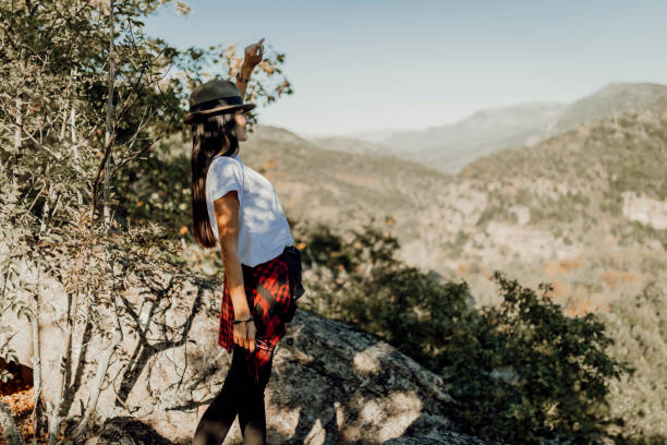 istock a young woman with hat looking at other mountain 1344927367