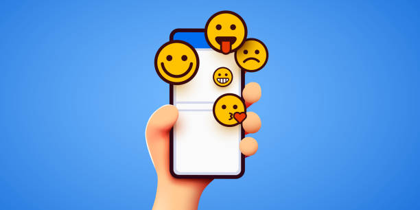 istock Hand holding phone emoticons. Social media and messenger chatting. 1344928460