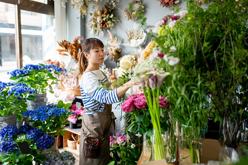 Young woman shopping for flowers on the Stortorget Square in Malmo in Sweden.