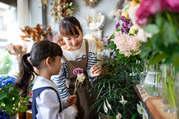 istock Florist helping a young child in her shop 1344928701
