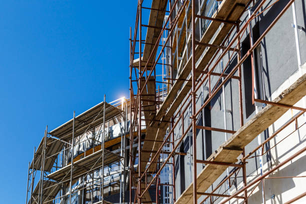 istock Extensive scaffolding providing platforms for work in progress on a new apartment block,Tall building under construction with scaffolds,Construction Site of New Building 1344929860