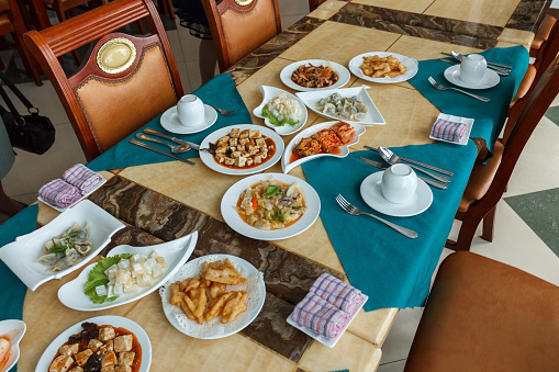 A table with snacks is served for tourists. Restaurant in Pyongyang. North Korea
